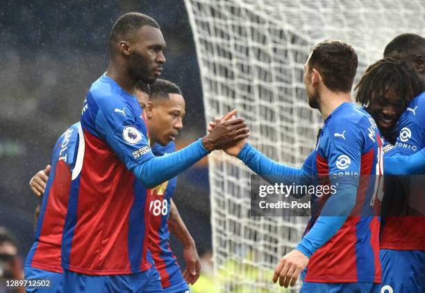 Christian Benteke of Crystal Palace celebrates with James McArthur after scoring their team's third goal during the Premier League match between West...