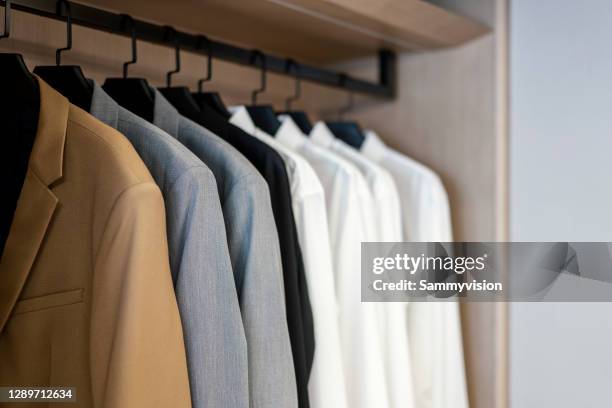 close-up of clothes hanging on rack at store - brown coat bildbanksfoton och bilder