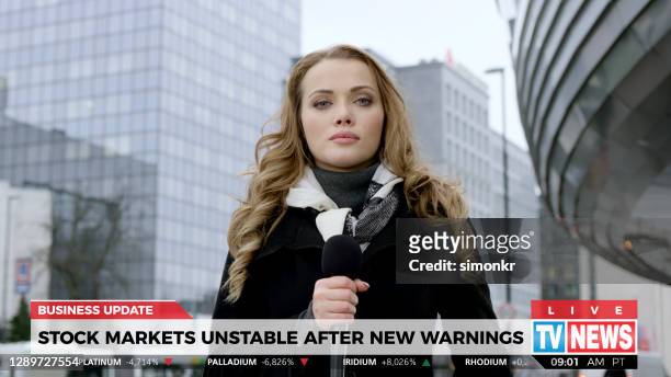 news reporter live broadcasting on urban street - news event stock pictures, royalty-free photos & images