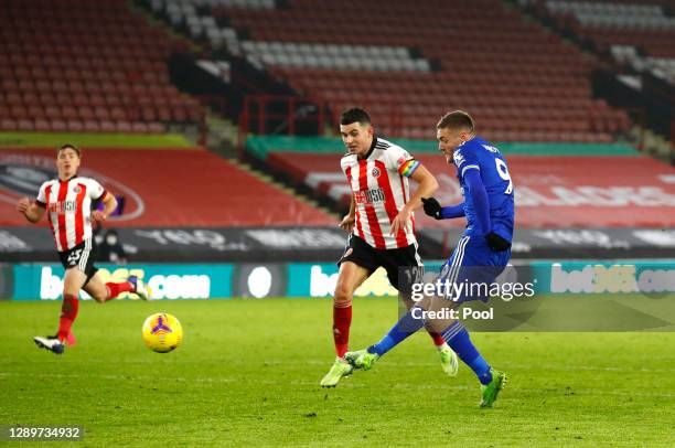 Jamie Vardy of Leicester City scores their sides second goal whilst under pressure from John Egan of Sheffield United during the Premier League match...