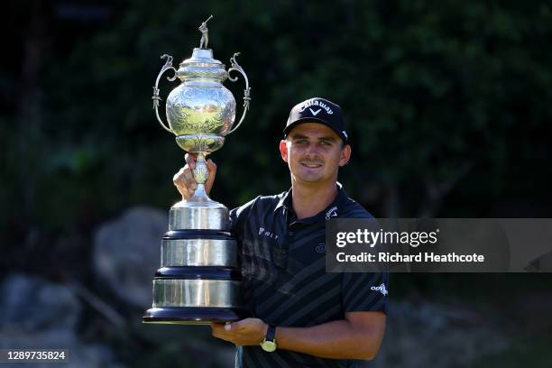 Christiaan Bezuidenhout of South Africa poses with the trophy after his victory during the final round of the South African Open at Gary Player CC on...