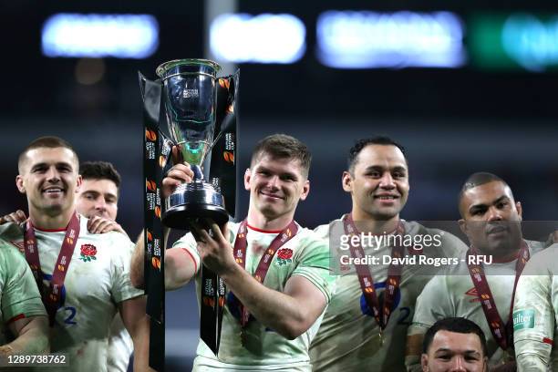 Owen Farrell of England celebrates as he lifts the Autumn Nations Cup trophy as Henry Slade, Ben Youngs, Billy Vunipola and Kyle Sinckler look on...