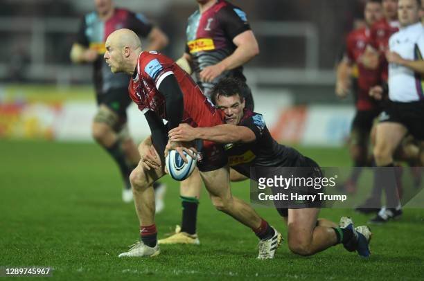 Joe Simpson of Gloucester Rugby is tackled by Will Evans of Harlequins during the Gallagher Premiership Rugby match between Gloucester and Harlequins...