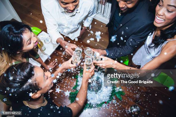 high angle view of friends toasting champagne at party - new years eve imagens e fotografias de stock