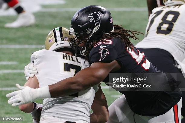 Steven Means of the Atlanta Falcons sacks Taysom Hill of the New Orleans Saints during the first quarter at Mercedes-Benz Stadium on December 06,...