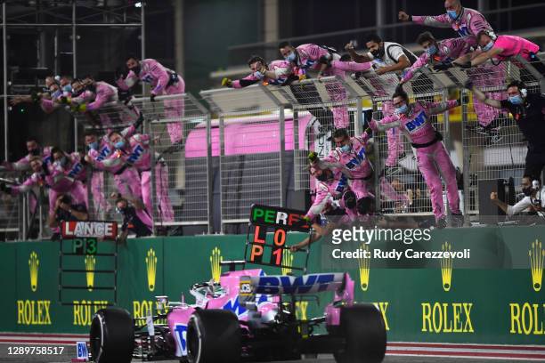 The Racing Point team celebrate on the pitwall as Sergio Perez of Mexico driving the Racing Point RP20 Mercedes crosses the finish line to win during...
