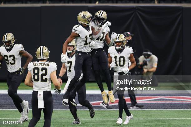 Michael Thomas of the New Orleans Saints and Alvin Kamara react following a third quarter touchdown against the Atlanta Falcons at Mercedes-Benz...
