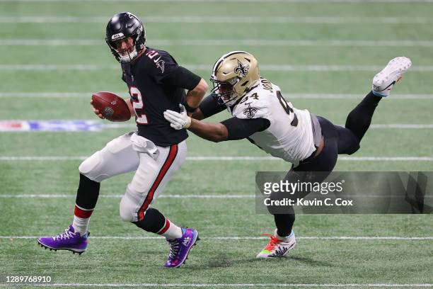 Matt Ryan of the Atlanta Falcons escapes a tackle by Cameron Jordan of the New Orleans Saints during the third quarter at Mercedes-Benz Stadium on...