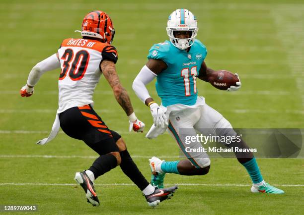 Wide receiver DeVante Parker of the Miami Dolphins runs with the ball against safety Jessie Bates III of the Cincinnati Bengals in the third quarter...