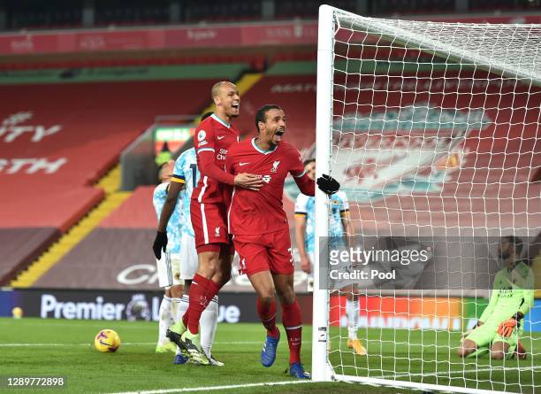 Joel Matip of Liverpool celebrates with team mate Fabinho after scoring their sides third goal during the Premier League match between Liverpool and...
