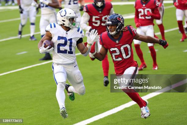 Nyheim Hines of the Indianapolis Colts scores a five-yard rushing touchdown past Justin Reid of the Houston Texans during the first half at NRG...