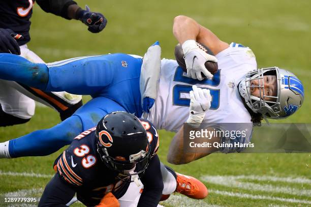 Hockenson of the Detroit Lions is tackled by Eddie Jackson of the Chicago Bears during the second half at Soldier Field on December 06, 2020 in...