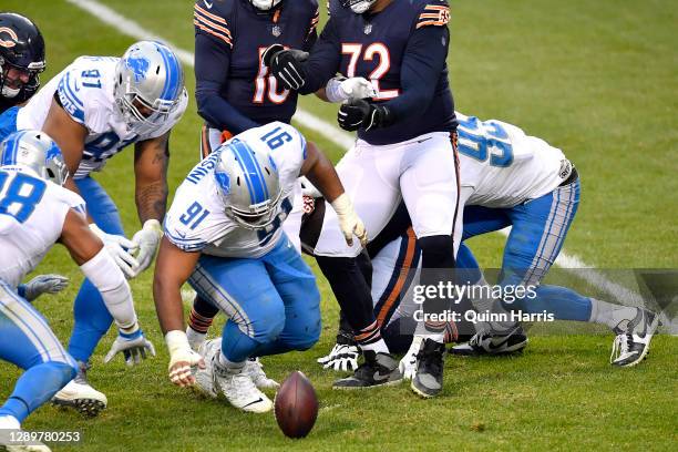 John Penisini of the Detroit Lions recovers a fumble lost by Mitchell Trubisky of the Chicago Bears during the second half at Soldier Field on...