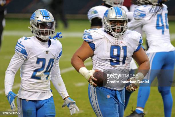 John Penisini of the Detroit Lions is congratulated by Amani Oruwariye after recovering a fumble against the Chicago Bears during the second half at...