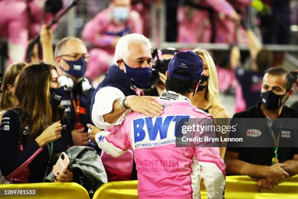 Race winner Sergio Perez of Mexico and Racing Point is congratulated by Lawrence Stroll in parc ferme after his maiden F1 victory during the F1 Grand...