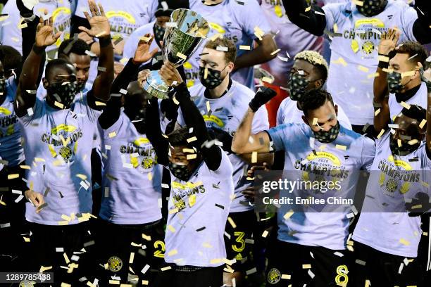 Luis Diaz of Columbus Crew and his teammates celebrate with the Eastern Conference trophy after their 1-0 win over the New England Revolution during...