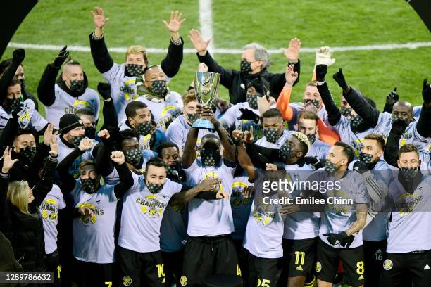 The Columbus Crew celebrates with the Eastern Conference trophy after their 1-0 win over the New England Revolution during the Eastern Conference...