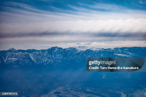 sunlight on snowcapped tateyama mountains in toyama prefecture of japan aerial view from airplane - toyama prefecture stock-fotos und bilder