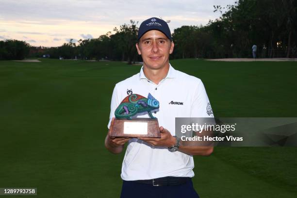 Carlos Ortiz of Mexico celebrates with the trophy for lowest scoring Mexican player during the final round of the Mayakoba Golf Classic at El...