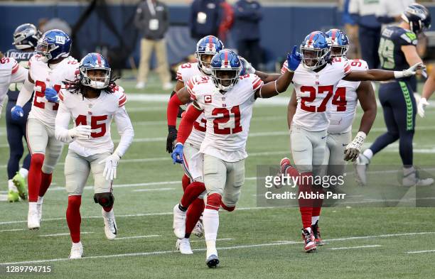 Madre Harper, Jabrill Peppers and Isaac Yiadom of the New York Giants celebrate an interception by Darnay Holmes , against the Seattle Seahawks...