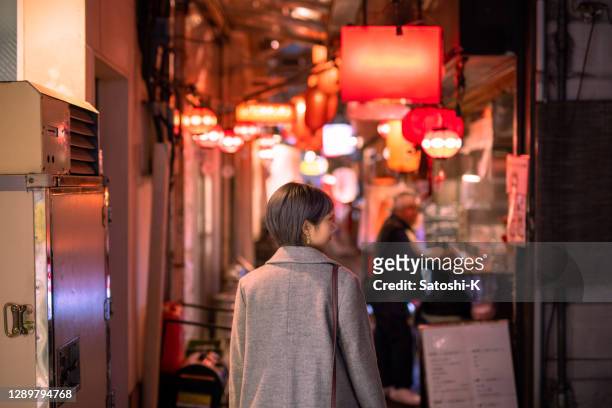 日本の「居酒屋」バーストリートを訪れる若い女性 - 酒場　日本 ストックフォトと画像