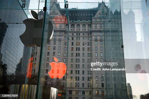 The Apple store logo in holiday colors is reflected against the Park Plaza Hotel on December 6, 2020 in New York City. Many holiday events have been...