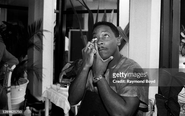 Donnie Simpson, host of 'Video Soul' playfully puts in a contact lens during 'hair and makeup' while preparing for his show during 'Motown Soul By...