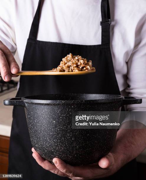 cooking buckwheat porridge. the cook prepares buckwheat porridge. - 茶粥 ストックフォトと画像