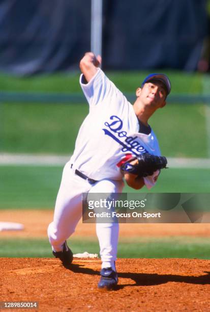 Hideo Nomo of the Los Angeles Dodgers pitches during a Major League Baseball spring training game circa 1996 at Holman Stadium in Vero Beach,...