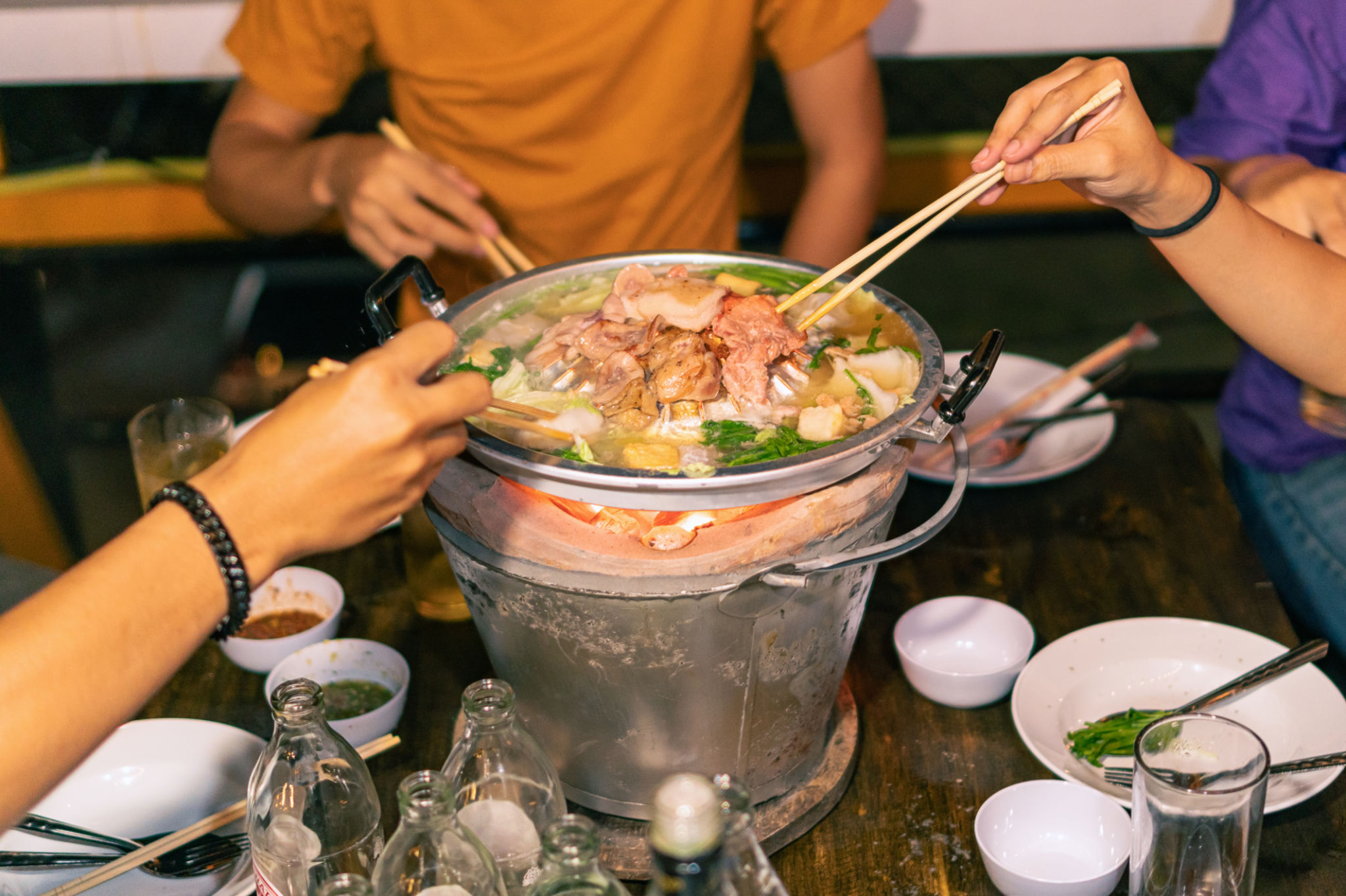Hand holding chopsticks eating Thai barbecue, popular street food Hand holding chopsticks eating Thai barbecue, popular street food