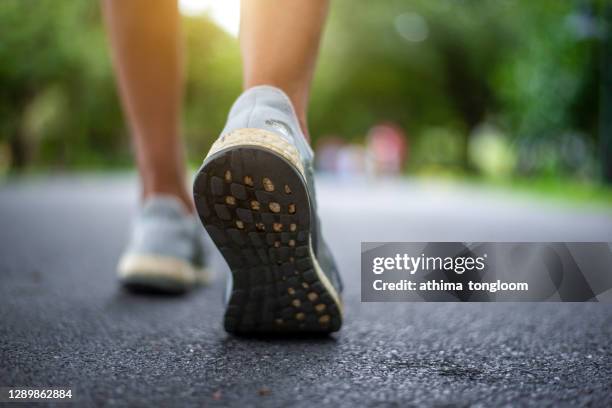 running woman in the park. - marathon feet stock pictures, royalty-free photos & images