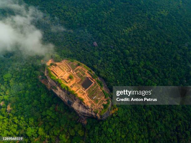 aerial view of sigiriya rock at misty morning, sri lanka. drone photo. - the ruins of civilization stockfoto's en -beelden