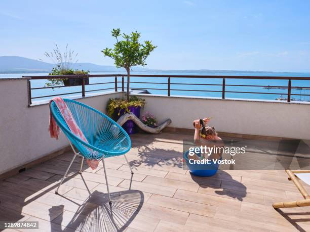 sun bath on the terrace - penthouse girl fotografías e imágenes de stock