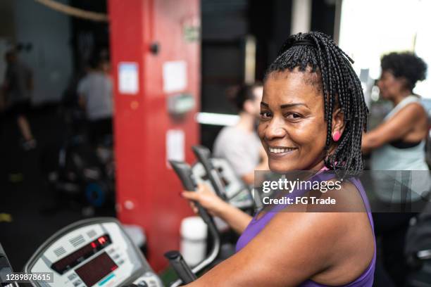 portrait of a mature woman in gym - format elliptical stock pictures, royalty-free photos & images