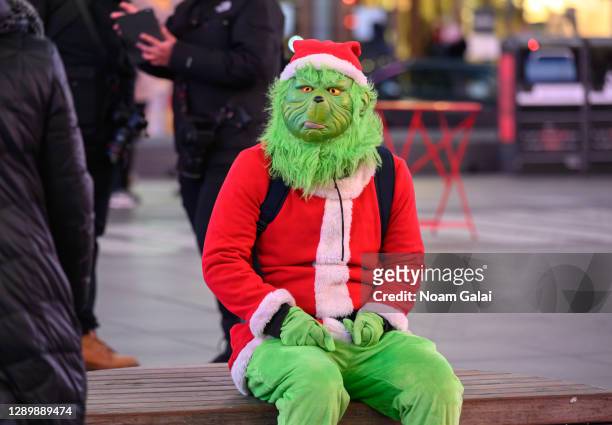 The Grinch visits Times Square on December 06, 2020 in New York City. Many holiday events have been canceled or adjusted with additional safety...