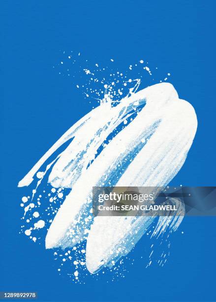 white paint splash on blue - paint fotografías e imágenes de stock