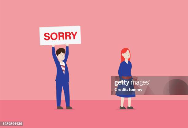 a man holds a sorry sign to a woman - im sorry stock illustrations