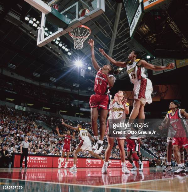 Cynthia Cooper, Guard for the Houston Comets and Edna Campbell, Guard for the Seattle Storm jump together to challenge for the rebound during their...
