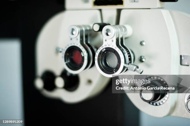 closeup image of a phoropter in optical store, eyesight equipment. - phoroptor stock pictures, royalty-free photos & images