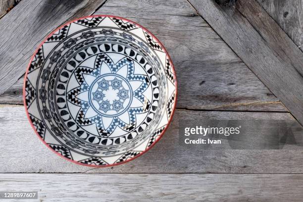 an empty bowl with blue pattern put on wooden table - blue bowl fotografías e imágenes de stock
