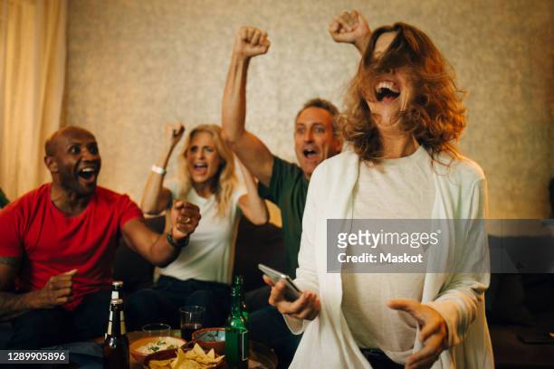 cheerful couples enjoying sports in living room at home - table fan stock pictures, royalty-free photos & images