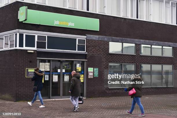 Shoppers walk past a Jobcentre Plus employment office on December 07, 2020 in Stoke-on-Trent, Staffordshire, England.
