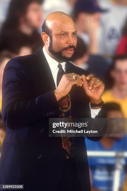 Head coach Mike Jarvis of the George Washington Colonials signals to his players during a college basketball game against the Rutgers Scarlet Knights...