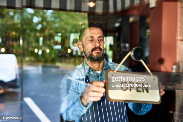 mature man opening restaurant - real people serious not looking at camera not skiny stock pictures, royalty-free photos & images
