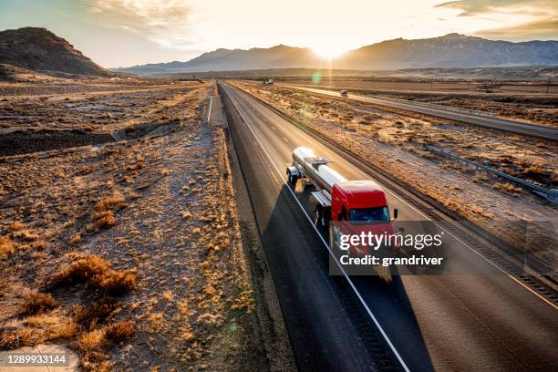 red cab tanker truck speeding down interstate seventy in utah - gas truck stock-fotos und bilder