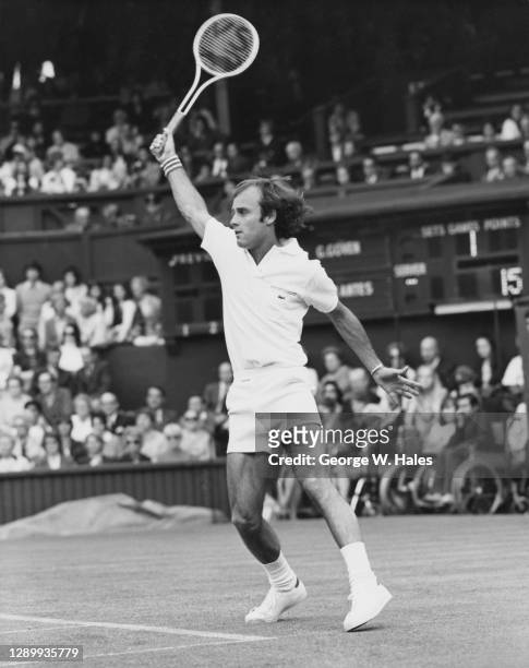 Georges Goven of France makes a backhand return against Manuel Orantes during their Men's Singles First Round match at the Wimbledon Lawn Tennis...