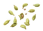 Cardamom pods whole and chopped fly on a white background. Isolated