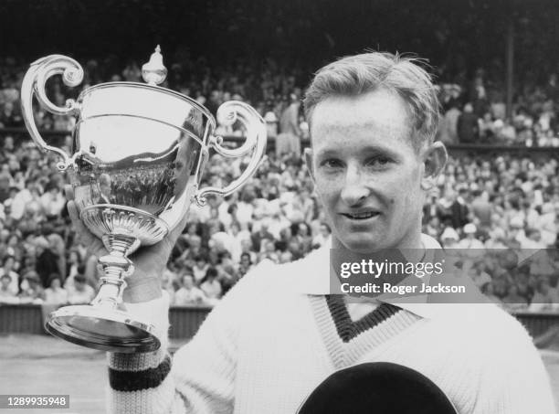 Rod Laver of Australia with the Gentlemen's Singles Trophy after defeating compatriot Martin Mulligan in the Men's Singles Final match at the...