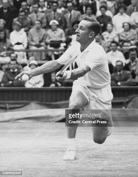 Rod Laver of Australia makes a forehand volley return against Barry MacKay during their Men's Singles Semi Final match at the Wimbledon Lawn Tennis...