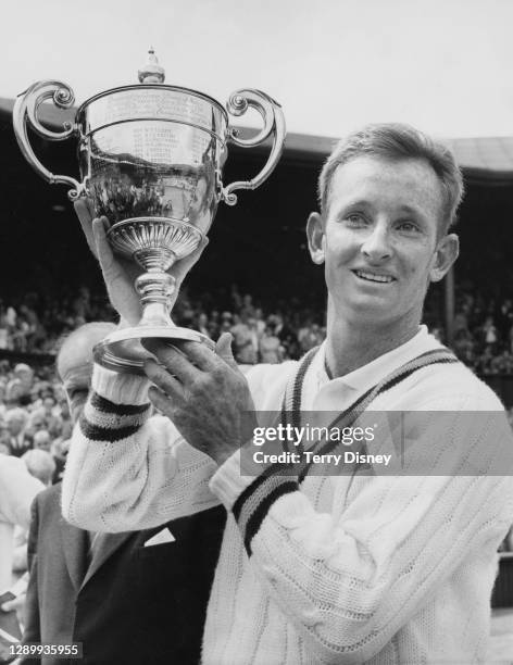 Rod Laver of Australia with the Gentlemen's Singles Trophy after defeating Chuck McKinley of the United States in the Men's Singles Final match at...